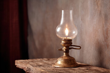 An old-fashioned kerosene lamp stands on a rustic wooden table, casting a warm glow in a dimly lit room, evoking nostalgia and vintage charm