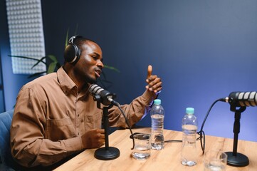 Man recording podcast using high tech microphones to interview guest, ensuring flawless video and...