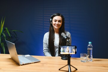 Female vlogger influencer speaking looking at camera, young woman blogger greets fans and talks...