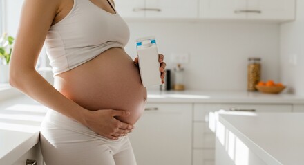 Expectant woman in white with beverage