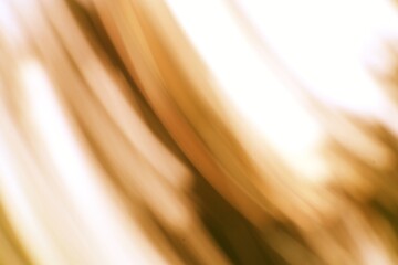 Abstract streaks of light and motion evoking golden hues of energy