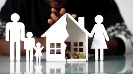 Broken White Model House with Paper Family Figures Hands Up conveying a sense of loss financial and uncertainity - Powered by Adobe