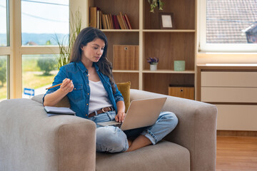 Young home-based online therapist in virtual counseling session, focused mental health professional...