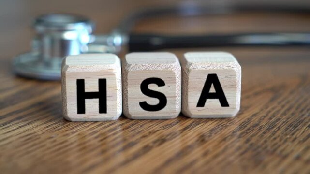 HSA Health Savings Account Concept Featuring Wooden Blocks and Stethoscope on Wood Surface