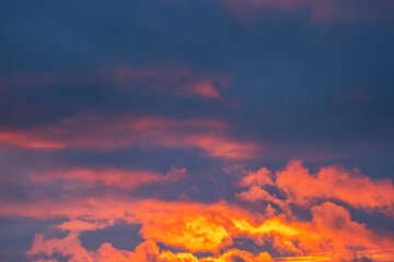 Vibrant Orange and Dark Blue Clouds in the Sky During Sunset or Sunrise. Beautiful Colorful Cloudscape as Background.
