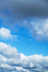 Blue Sky with Fluffy Clouds. Clear Weather Background. Natural Cloudscape for Environmental Concept.