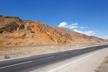 asphalt road in the mountains and blue sky