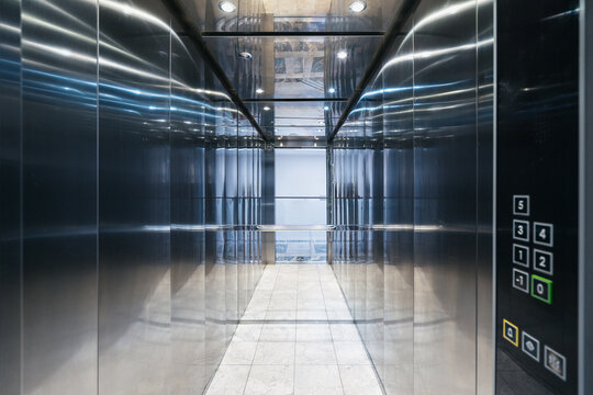 Modern elevator interior in a residential building with sleek metal design