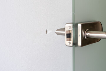 Modern door handle design in a minimalist apartment environment