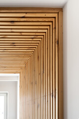 Elegant wooden slatted wall design enhances modern interior spaces significantly