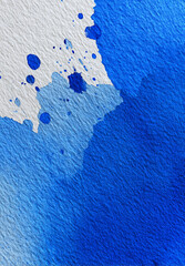 Artistic deep blue ink texture with soft watercolor gradient and splatter on textured paper, creating calming and creative abstract background