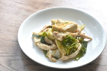 fried slice tofu and chicken with garlic chive in soy sauce on plate