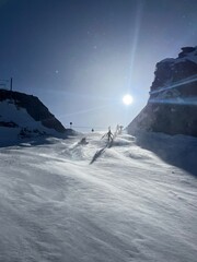 Adventurous Skiers Enjoying a Winter Day on the Slopes Under the sun 