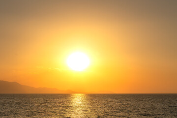 sunset over Van lake and big looking sun