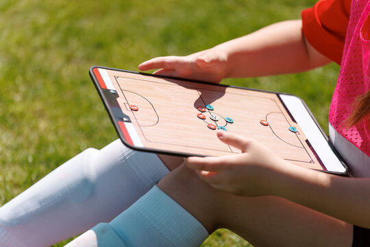 Young Soccer Player Analyzing Game Strategy on Tactics Board During Outdoor Practice Session on Grass Field - Powered by Adobe