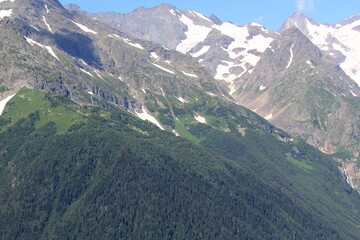 Naklejka premium non-melting snow in the mountains of the North Caucasus in Dombai on a sunny summer day