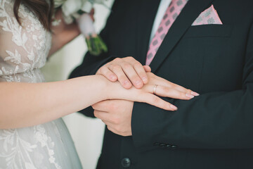 Couple exchanges vows during intimate wedding ceremony with soft colors and tenderness on a sunny day