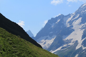 mountain peaks of elbrus region in dombai in midsummer