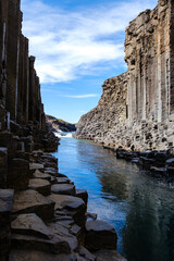 Discover the breathtaking beauty of Studlagil Canyon, featuring towering basalt columns and...