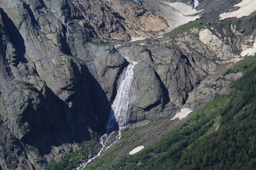 Waterfalls from melting snow in the mountains of Elbrus region in Dombai