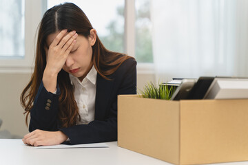 Office worker packing stuff to leave office after resign from job.