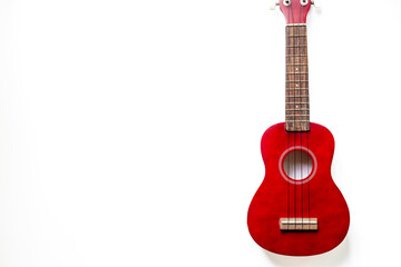 Fototapeta premium Brown red four string ukulele small guitar. Musical instrument, top view