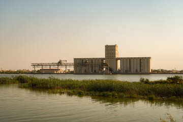  Grain Silo Stands Tall on Riverbank, Vital Hub