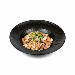 A black bowl filled with vibrant rice, topped with fresh herbs and sesame seeds, elegantly presented on a white background