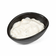 A small black bowl filled with creamy white sauce, mayonnaise, placed on a clean white background