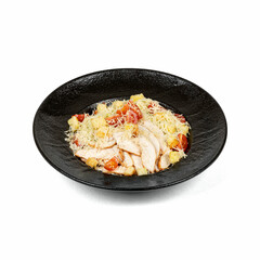 A black bowl filled with fresh Caesar salad, featuring sliced chicken breast, cherry tomatoes, croutons, and grated cheese