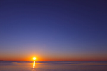 A beautiful sea sunset with a clear, cloudless sky