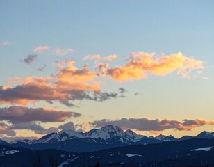 Mountain range at sunset, soft pink clouds