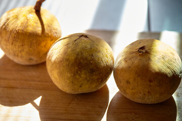 Close-up view of Santol fruit on cutting board