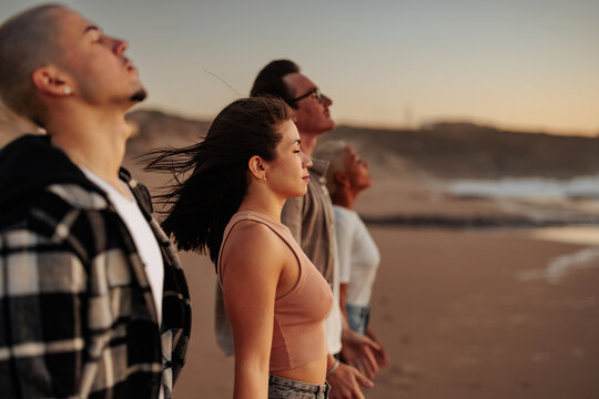 Friends breathing fresh air on beach at sunset, enjoying nature and freedom
