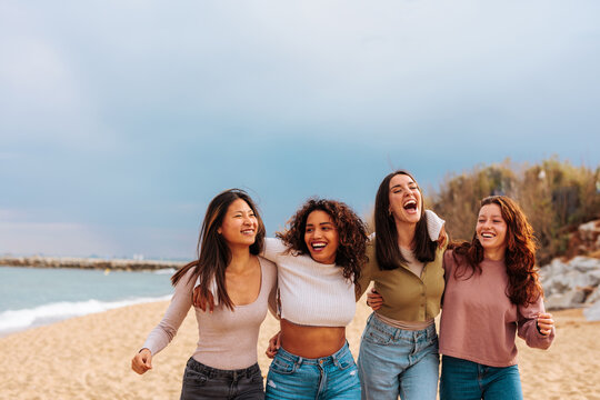 Female friend group enjoying sunny beach day