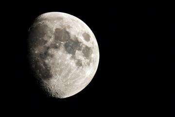a full moon is seen in the dark sky