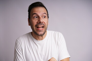 Fototapeta premium Male Model Showing Different Emotions on White Studio Background