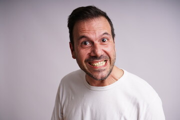 Obraz premium Male Model , mad, Showing Different Emotions on White Studio Background