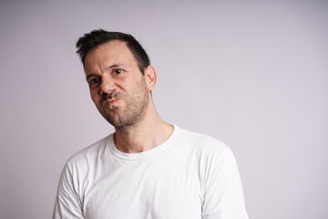 Fototapeta premium Male Model Showing Different Emotions on White Studio Background