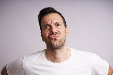 Fototapeta premium Male Model Showing Different Emotions on White Studio Background