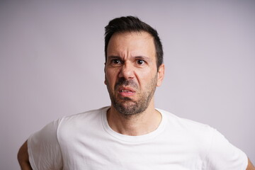 Fototapeta premium Male Model Showing Different Emotions on White Studio Background