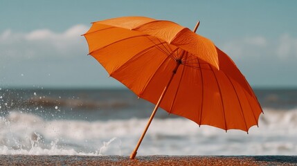 Orange Umbrella on Sandy Beach with Waves