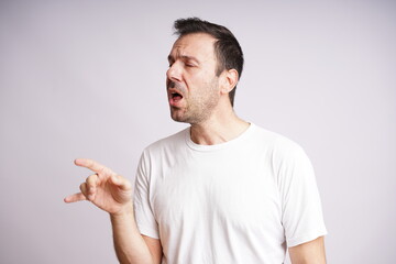 Fototapeta premium Male Model Showing Different Emotions on White Studio Background