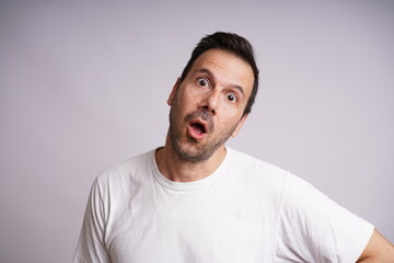Obraz premium Male Model Showing Different Emotions on White Studio Background