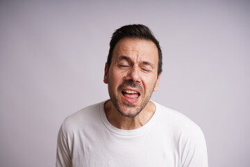 Obraz premium Male Model Showing Different Emotions on White Studio Background