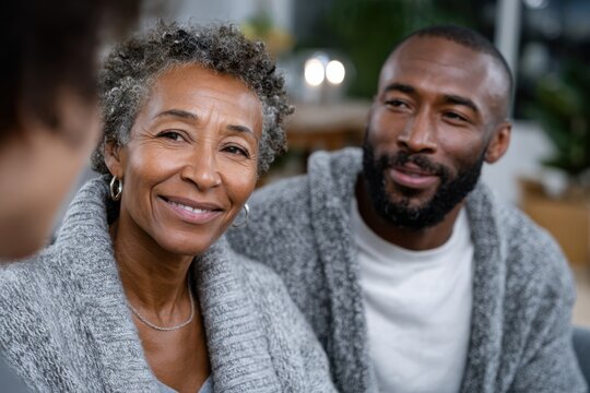 An affectionate senior couple shares smiles and joy during a warm conversation, highlighting the beauty of companionship and connection in later years of life.