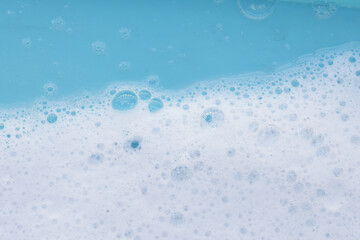 Blue water with white foam bubbles