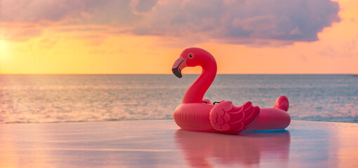 Playful summer pool scene sunset pink flamingo inflatable sea view. Fun happy vacation vibes perfect for tropical relaxation colorful water background. Joyful beach travel tourism decoration copyspace