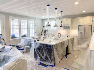 A luxury kitch covered in plastic sheets ready for painting