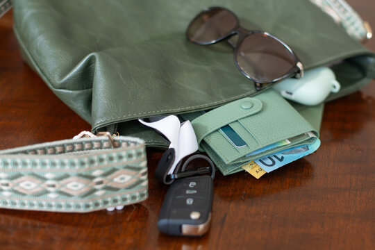 women's handbag with purse, key fob, airpods and sunglasses